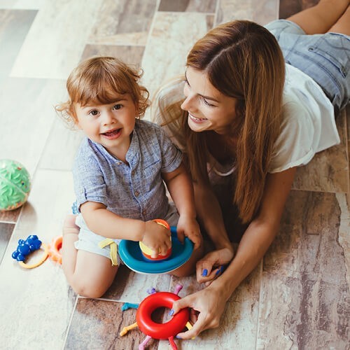 Mom and child playing on flooring | Stearns Super Center